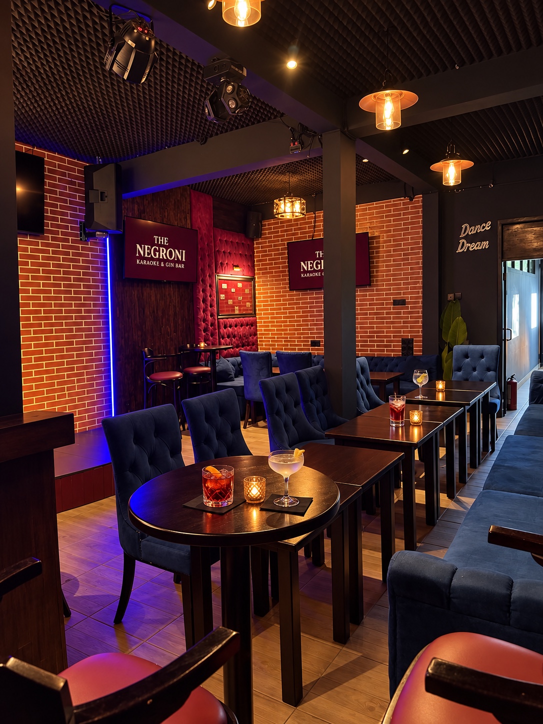 The karaoke room with tables, sofas and screens